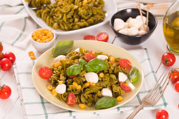 Fusilli pasta with cherry tomatoes and sweet corn.