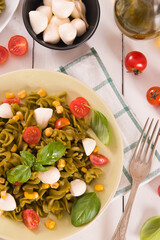 Fototapeta na wymiar Fusilli pasta with cherry tomatoes and sweet corn.
