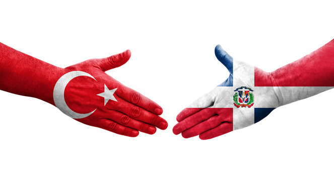 Handshake between Dominican Republic and Turkey flags painted on hands, isolated transparent image.