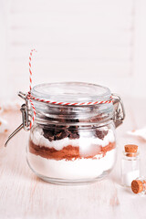 Christmas gift cookie mix in glass jar on wooden table