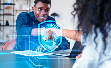 African American businessman shakes hands with businesswoman aft