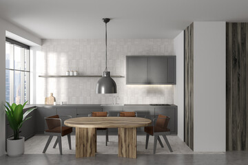 Modern kitchen interior with eating and cooking zone, panoramic window
