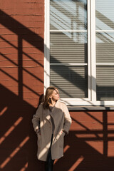 Portrait of a beautiful young woman outdoors. Happy woman wearing in coat