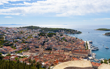 Fototapeta premium The town of Hvar on the Hvar island in Dalmatia, Croatia as seen from the Spanish Fortress (Tvrdava Fortica), with the Adriatic sea in the background.
