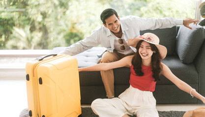 Asian couple man and woman smiling together enjoy departure fly pose for vacation travel