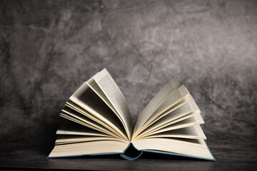 Composition of an open book on a dark background