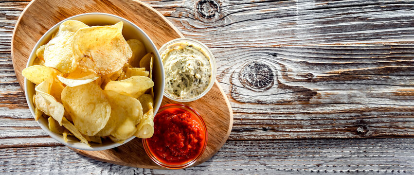 Composition With A Bowl Of Potato Chips And Dipping Sauces