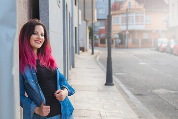 Fototapeta premium urban young woman leaning on the wall in the street