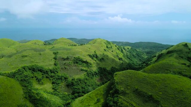 landscape with green hills and clouds and sky, Nusa Penida Hills, Teletubbies  Hill, Bali, Aerial Shot, Indonesia