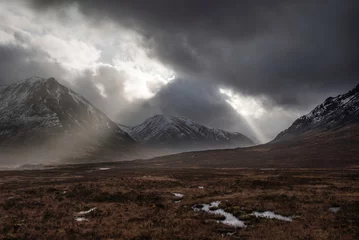 Fotobehang Chocoladebruin Majestic dramatic Winter sunset sunbeams over landscape of Lost Valley in Etive Mor in Scottish Highlands  © veneratio