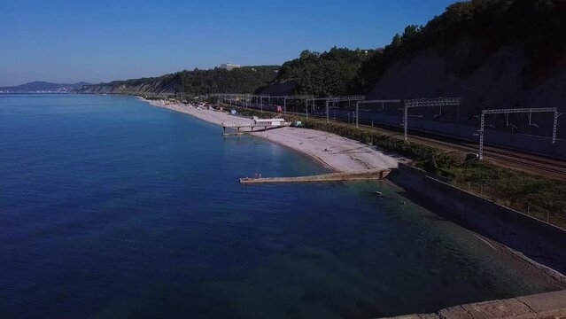 over a wide pebble beach and a railway on the Black Sea coast of the South of Russia near the resort of Shepsi - view from above