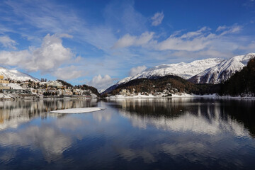 Saint Moritz, Switzerland: Reflection of the Saint Moritz village in the lake on a winter day in Canton Graubunden in the alps in Switzerland