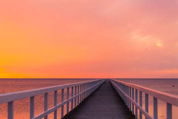 Beautiful sunset over the sea with wooden pier