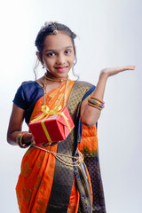 Fototapeta na wymiar indian marathi little girl in traditional blue navwari saree on white background