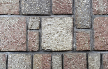 Multicolor old stone wall aged rocks history architecture. Square blocks creative building concept