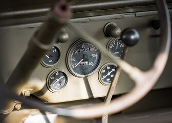 WW2 old US jeep speed dial dashboard in restored world war two military American 4x4. - obrazy, fototapety, plakaty