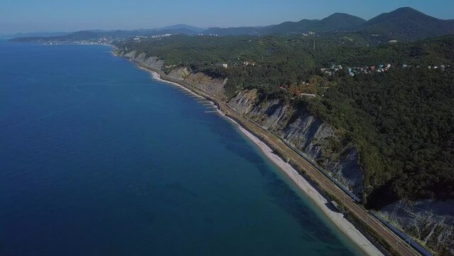 flight over the sea near the Black Sea beaches and wooded mountains near the city of Tupse (South of Russia) on a sunny summer day