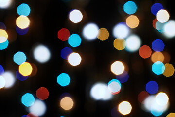 Obraz premium multicolored festive lights on a black background screensaver backdrop