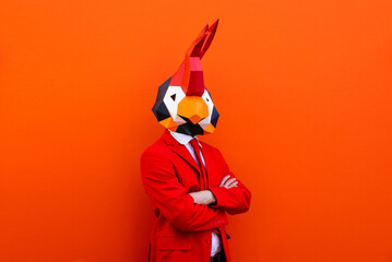 Cool man wearing  funny 3d origami mask and costume on colorful background