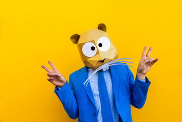 Fototapeta na wymiar Cool man wearing 3d origami mask and funny costume on colorful background