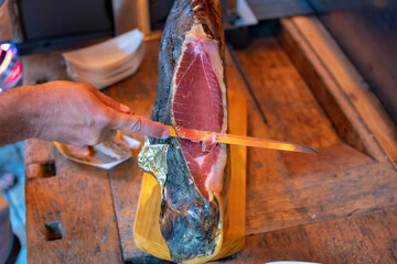 Argentine ham in one piece is cut with a knife