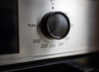 Close up of knob on oven, turned on