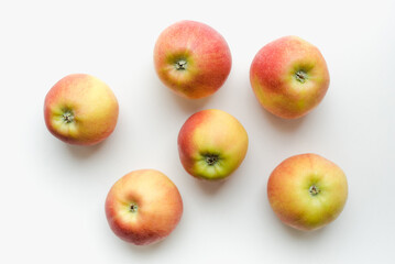 Red apples on a white background. Texture with apples.