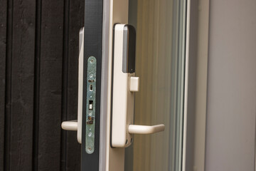 View of open front door of villa with white digital lock. Sweden.