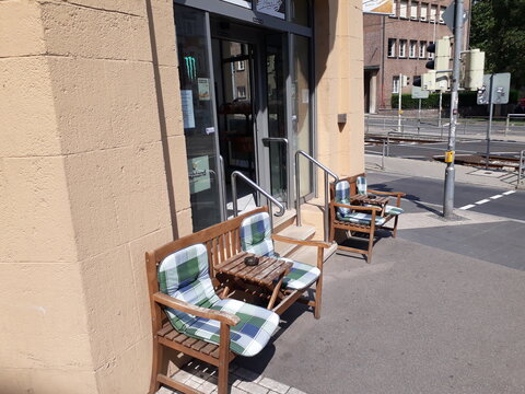 wmpty chairs in front of  a cafe bar