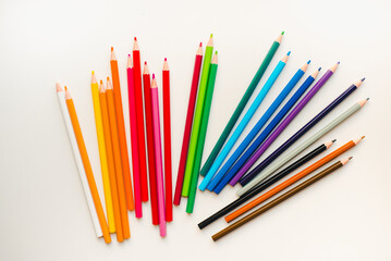 Colored pencils on a white background. Multicolored pencils.