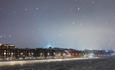 December 14, 2021, Moscow, Russia. Broken ice floes on the Moscow River during a snowfall on a winter evening.