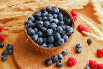 blueberry. blueberries in coconut peel on a wooden table