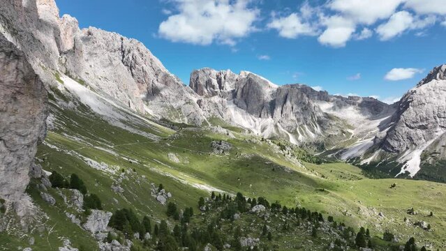 Dolomite Mountains, Dolomite Alps or Dolomitic Alps, are a mountain range located in northeastern Italy. Unesco world heritage. limestone alps grassland and cliff nature aerial drone overhead view.