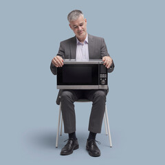 Man holding a microwave oven