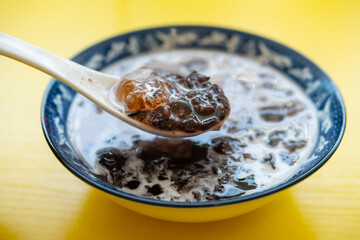 angle view syrup of peach resin with black glutinous rice and coconut juice