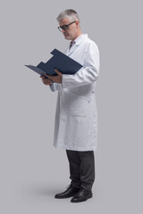 Doctor checking medical records in a file