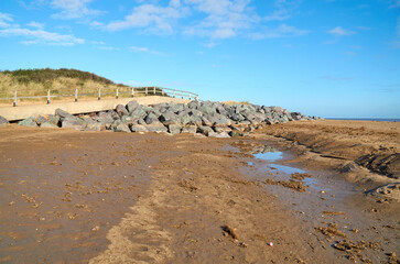 Fototapeta na wymiar Rocks preventing beach erosion