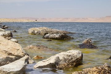 Rocky shore of Qarun Lake with a mountains and Clear Sky, Faiyum,  Egypt