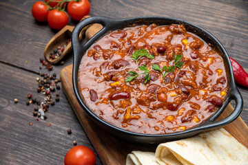 Bean and corn soup or ragout, red bean stew on a wooden background. Food Protein Vegan dish	