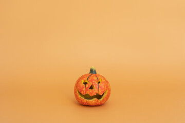 Colourful halloween pumpkin on orange background with copy space. Minimal autumn fall holidays concept