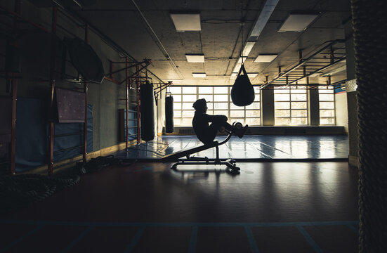 Crossfit Men Endurance Strength Training In The Gym. Silhouette Shot In Front Of The Window