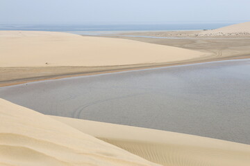 white dunes next to the inland sea in the desert of Qatar