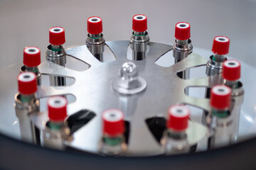 Vials with red caps in centrifuge rotor - laboratory equipment. Pharma industry, science, medicine,...