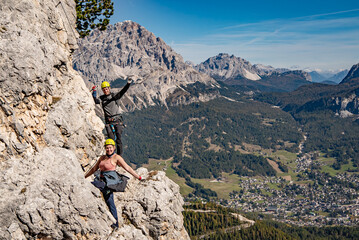 2 climbers on the top of mountain, via ferrata in dolomite's 