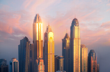 Dubai Marina skyscrapers complex of residential and office buildings at sunset. Dubai, UAE