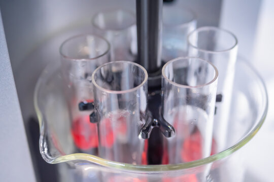 Close up: automatic tablet tester for measuring disintegration time of tablets, capsules. Automated technology, healthcare, manufacturing, pharmaceutical, laboratory equipment concept