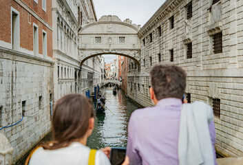 Tourists  tanding on Ponte della Paglia, watching gondolas 