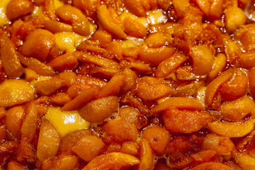 Apricots are cooked in a pan. Apricot jam. Pieces of fruit. Home preservation.