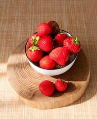juicy strawberries in a white plate on the table