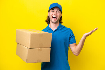 Fototapeta na wymiar Delivery handsome man isolated on yellow background with shocked facial expression